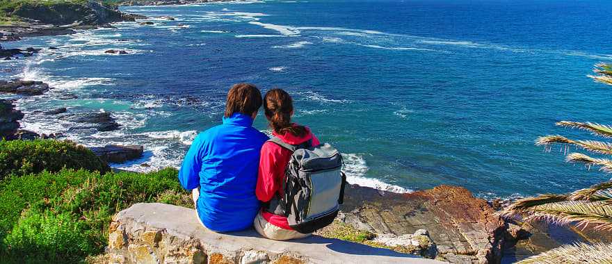Happy couple looks at the beautiful view of the Old Harbor, Hermanus