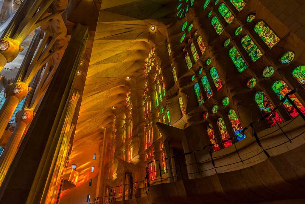 Afternoon light streaming through the stained glass windows of La Sagrada Familia in Barcelona, Spain