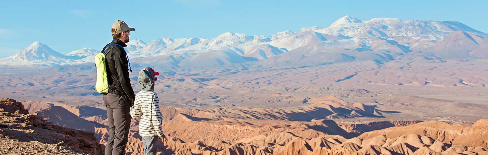 Father and son, hiking in Valle de la Muerte in Atacama Desert, Chile.