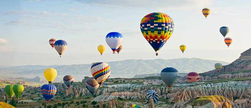 Colorful balloons fly over the Cappadocia valley in Turkey