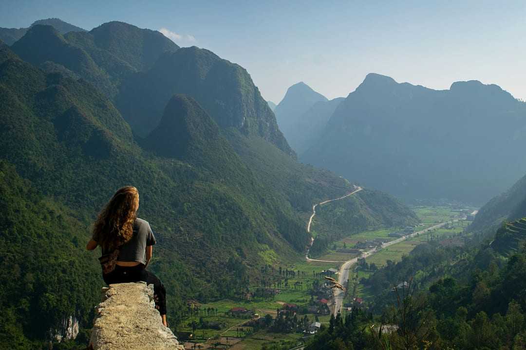 Woman sitting at an overlook along the Sky Path in Ha Giang, Vietnam