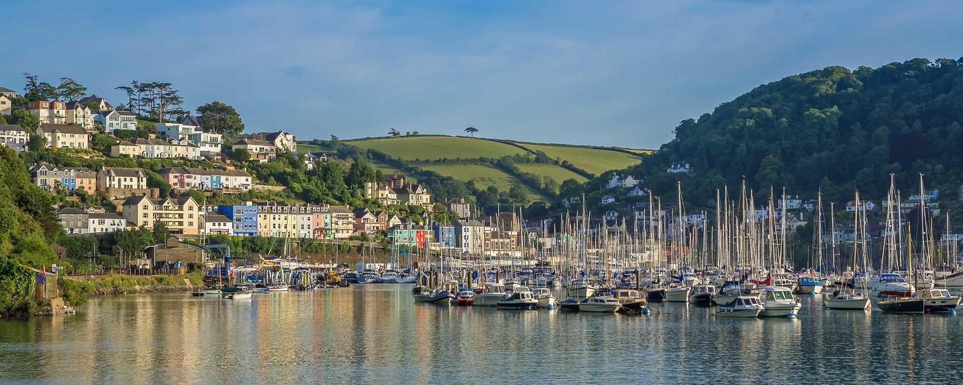 Kingswear village on the hillside and harbor with boats on the banks of the River Dart in the South Hams area Devon, England