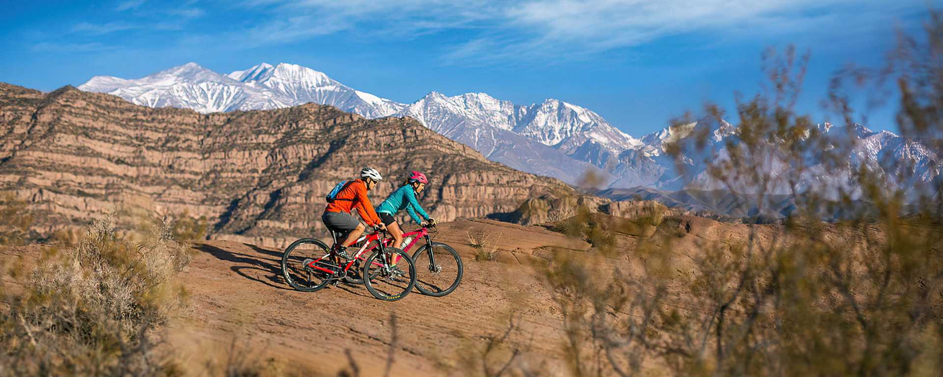 Couple biking near Potrerillos in the Mendoza Province, Argentina