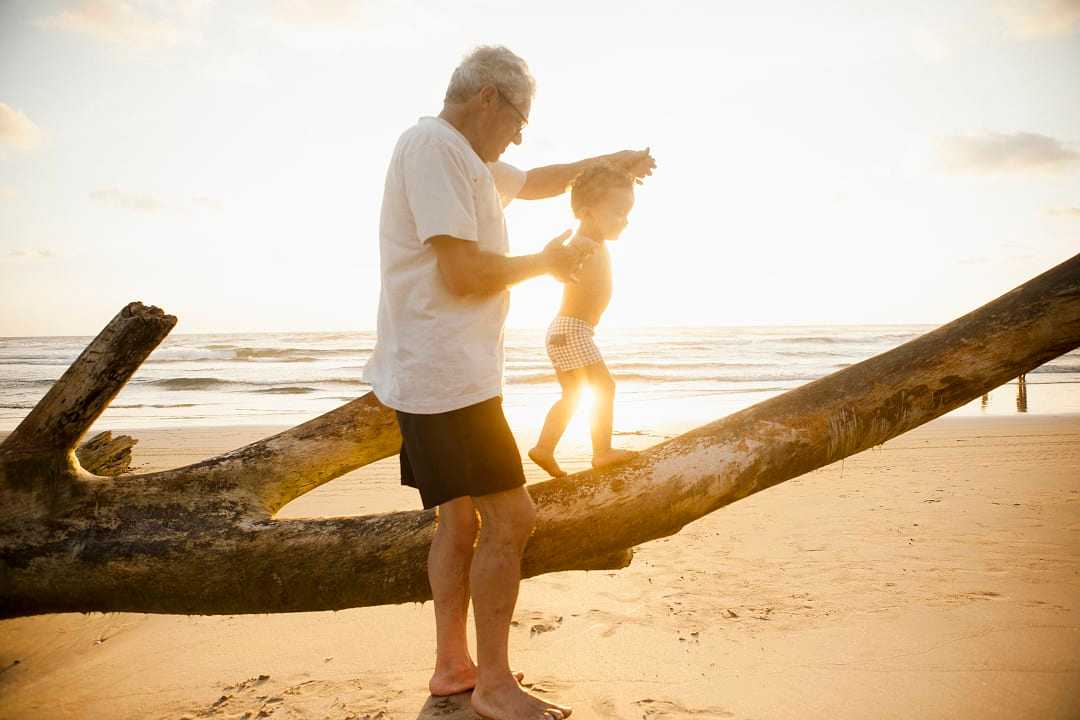 Grandfather with his grandson on the beach in Latin America