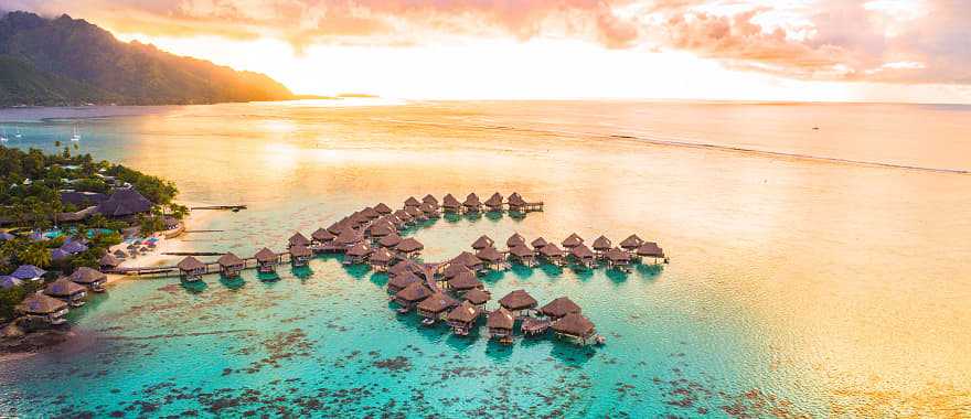 Overwater bungalows along coral reef in Moorea, French Polynesia