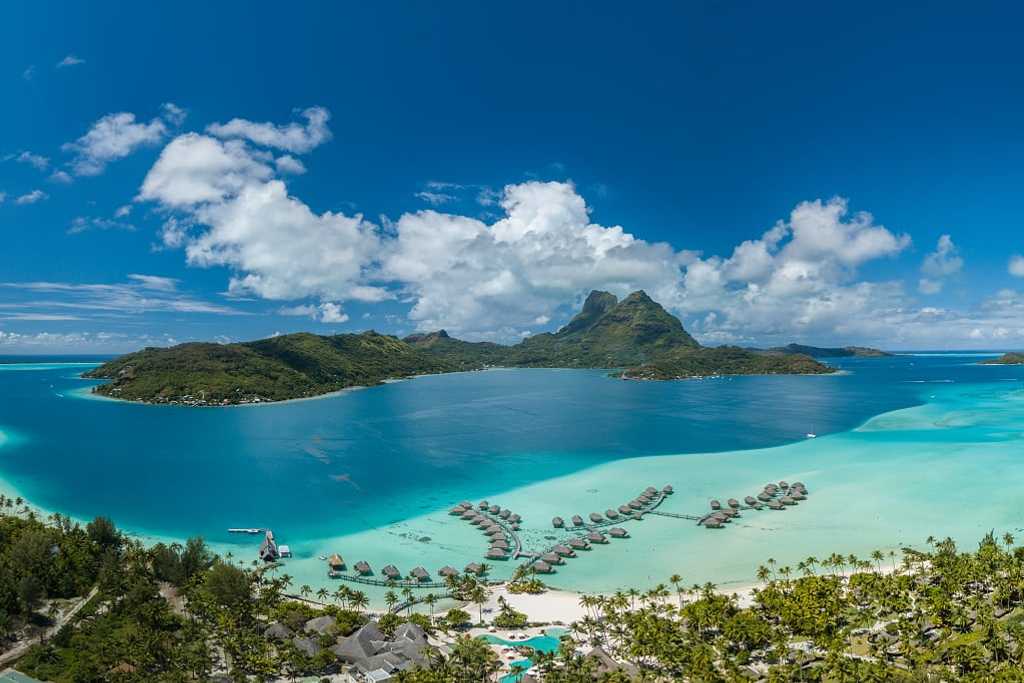Aerial view of luxury overwater bungalows on Bora Bora island in French Polynesia.