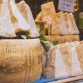 Cheese shop displaying Parmigiano-Reggiano cheeses. 