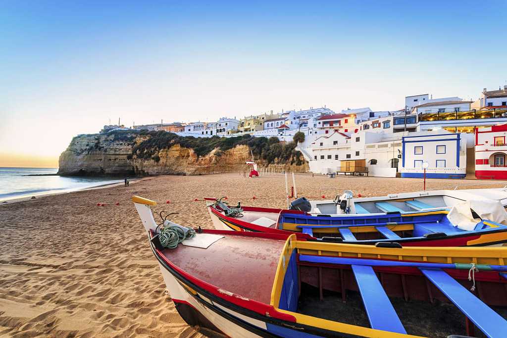 Beautiful beach with colorful boats in Carvoeiro in the Algarve region of  Portugal