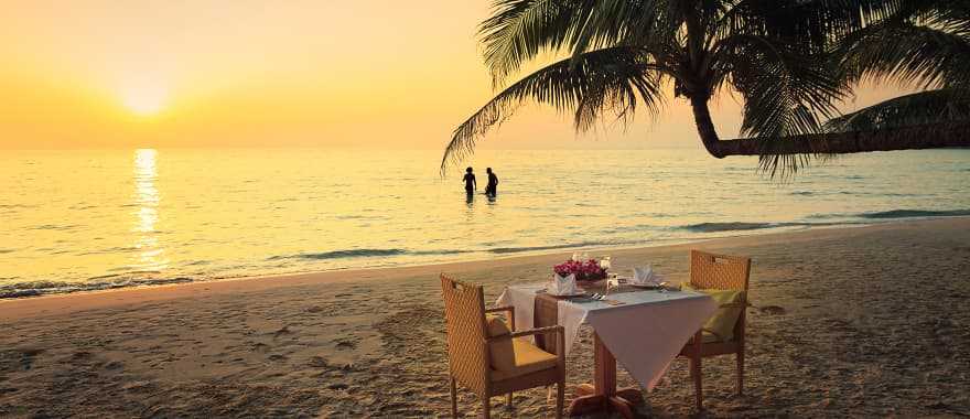 Honeymoon couple enjoying a romantic dinner on the beach in Costa Rica