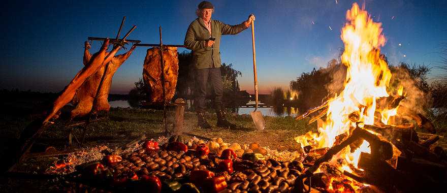 Chef Francis Mallmann tends the fires at Siete Fuegos restaurant in Mendoza, Argentina