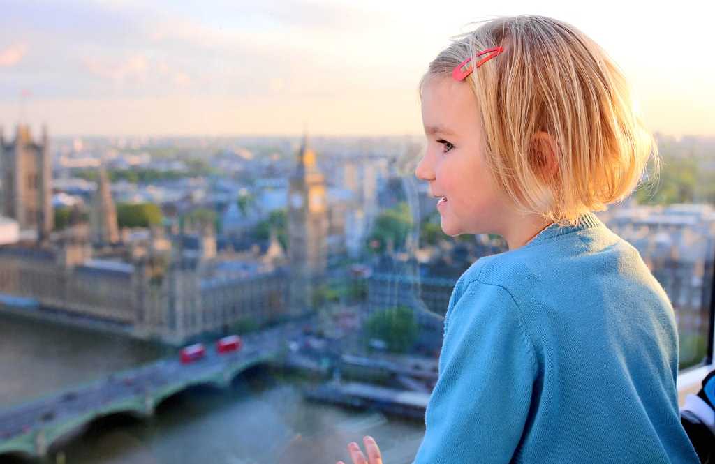 Westminster Abbey in London, England Little girl at sunset observing the Westminster Abbey in London