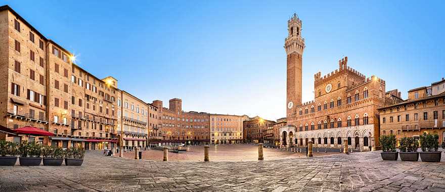 Piazza del Campo with gothic town hall building and tower in Siena, Italy