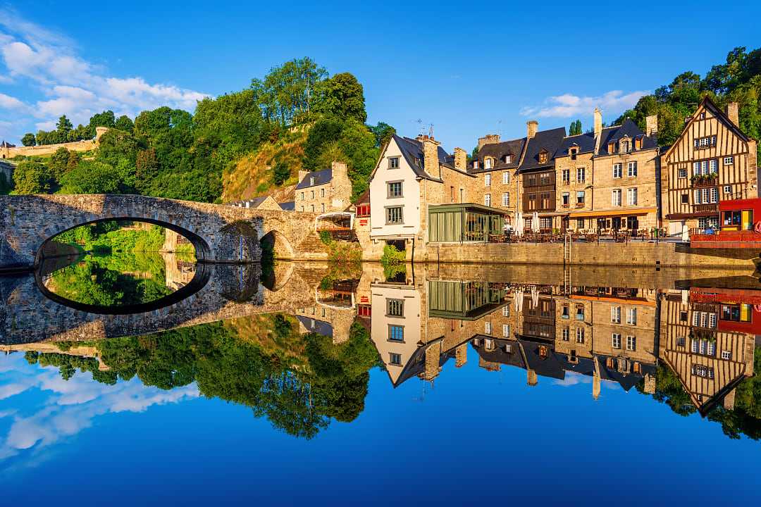The old stone bridge and medieval houses in Port Dinan town, France