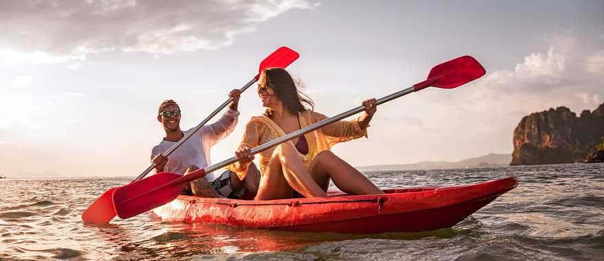 Happy couple kayaking in Thailand