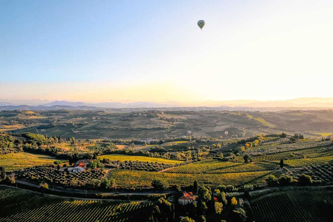Sunrise hot air balloon ride over the vineyards of Tuscany, Italy