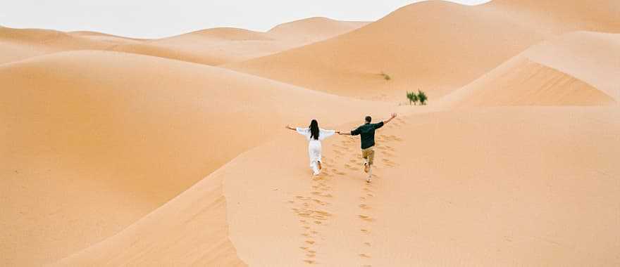 Couple at the Sahara desert in Morocco