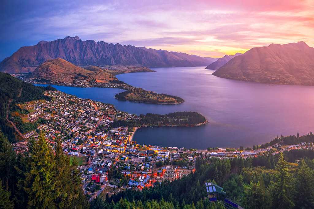 Aerial view of Queenstown at twilight with Lake Wakatipu and The Remarkable Mountains in New Zealand.