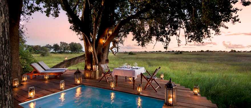 Guest private dining on the pool deck at Duba Plains Camp in the Okavango Delta, Botswana