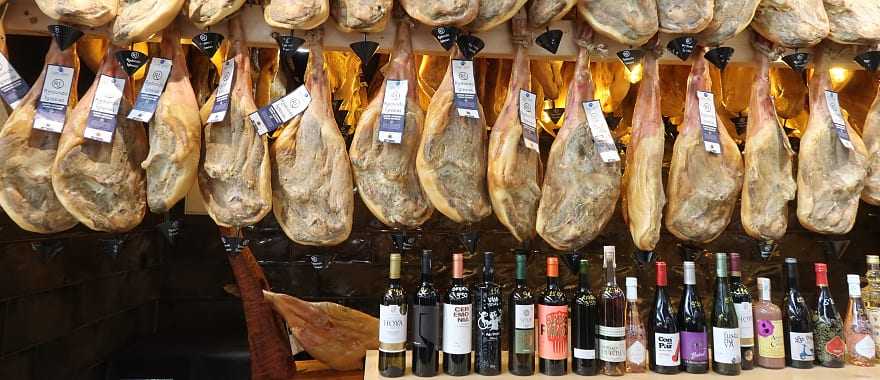 Jamon and wine for sale at a market in Spain.