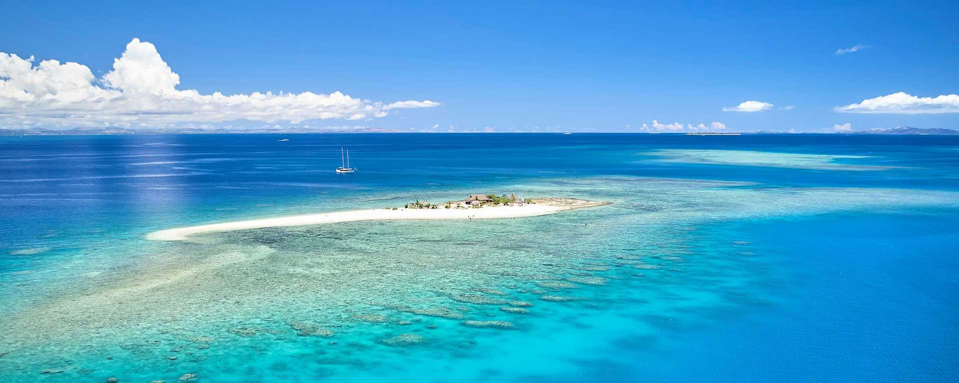 Romantic remote island with coral reef in the Fijian Island