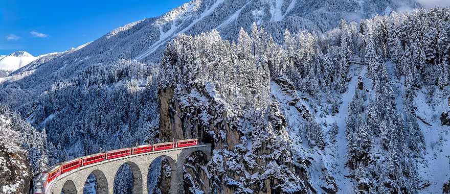 Glacier Express train traveling through the alps in Switzerland