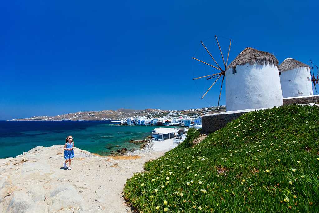 Girl and windmills in Mykonos