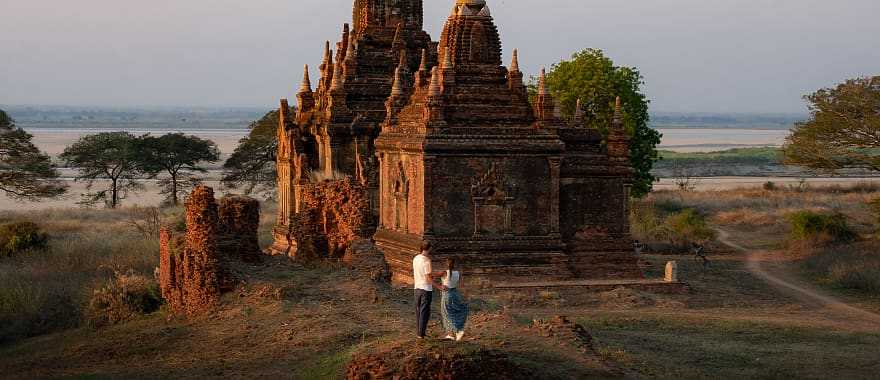 Couple enjoying view of a buddhist temple in Myanmar