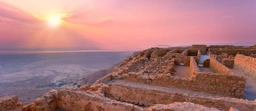 Sunset over Masada fortress in Judaea desert, Israel Sunset over Masada fortress in Judaea desert, Israel