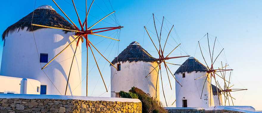 Famous windmills of Mykonos town at romantic sunset, Greece