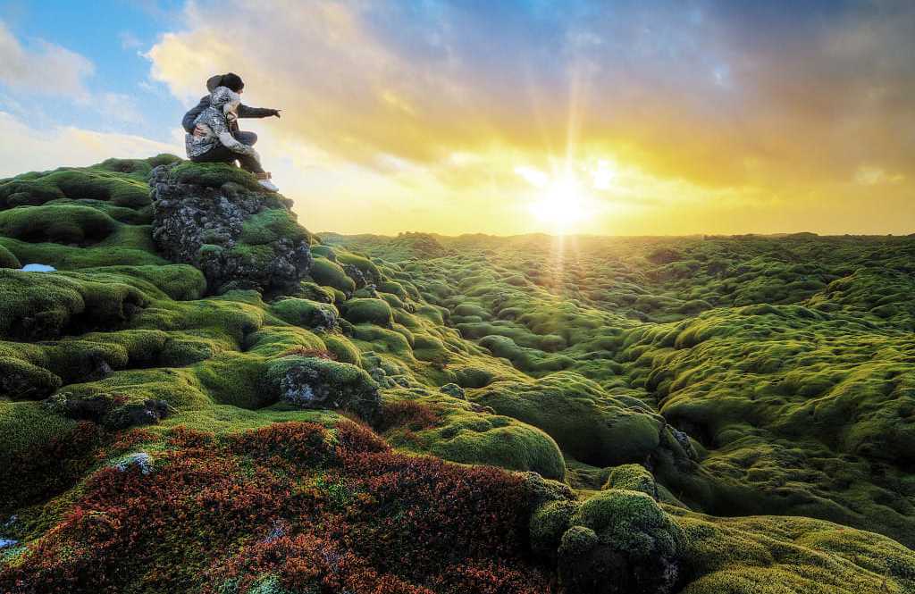 Eldhraun lava field in Southern Iceland Couple watching the sunrise over Eldhraun lava field in Southern Iceland