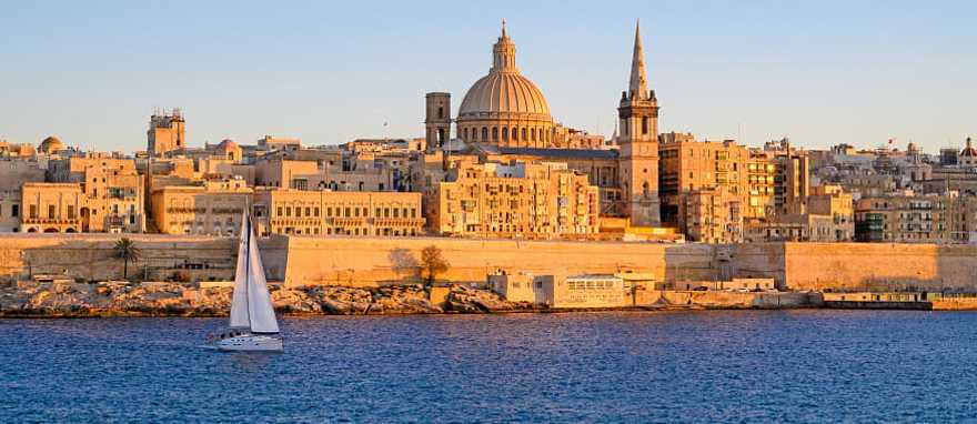 Sailboat along seafront of Valletta on the Island of Malta in the Mediterranean Sailboat along seafront of Valletta on the Island of Malta in the Mediterranean