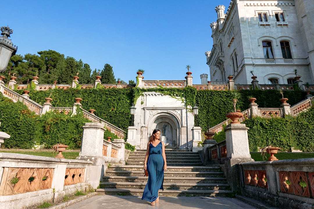 Woman walking the grounds at Castello di Miramare in Trieste, Italy