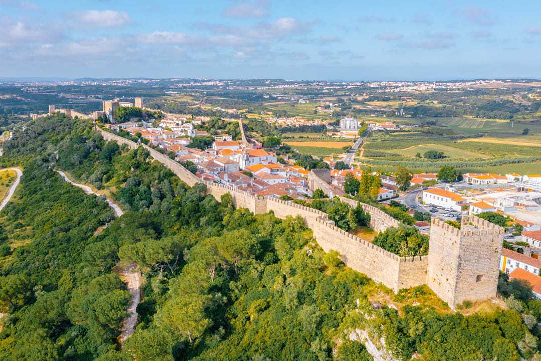 Panorama of the hilltop town of Obidos surrounded by medieval wall