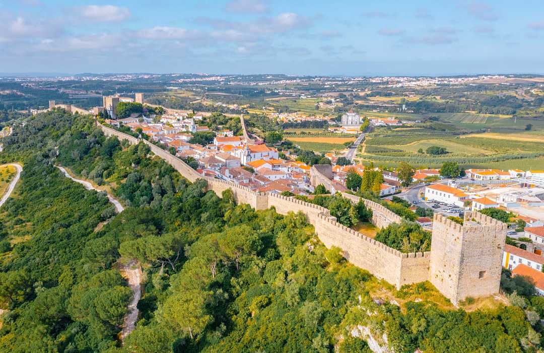 Obidos, Portugal Panorama of the hilltop town of Obidos surrounded by medieval wall