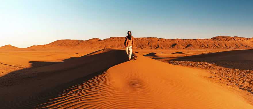 Solo traveler on sand dunes in Morocco