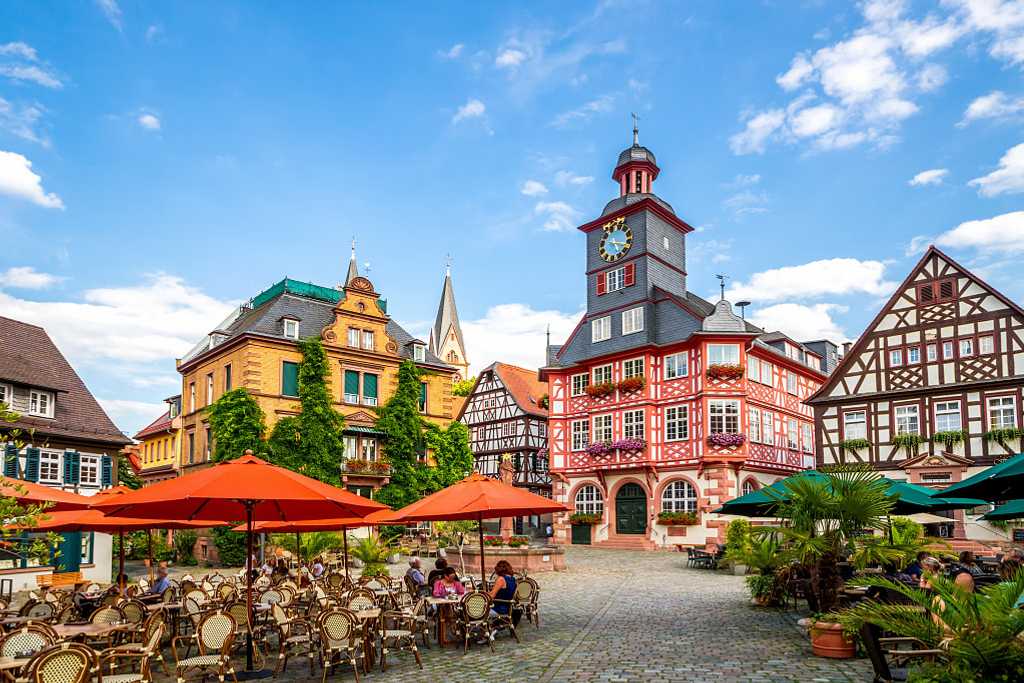 Cafes with outdoor seating and the half-timbered buildings in the market square of Heppenheim, Germany