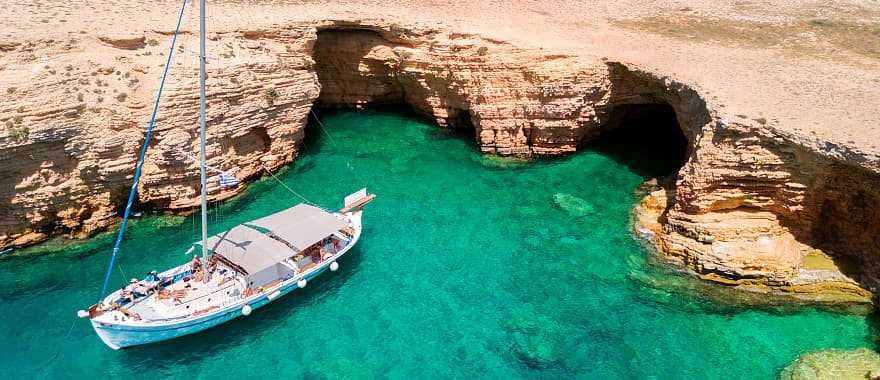 Private yacht anchored at Ksylobatis caves near Koufonisi, Cyclades, Greece.