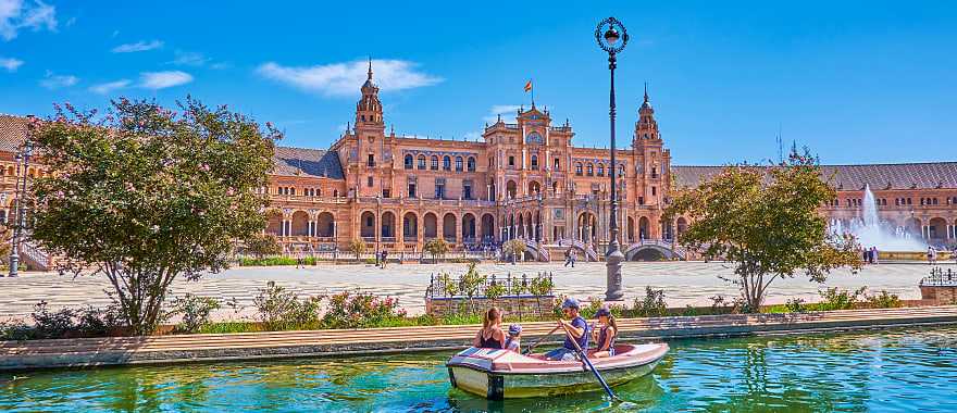Family boating in the canal at Plaza de Espana in Seville, Spain