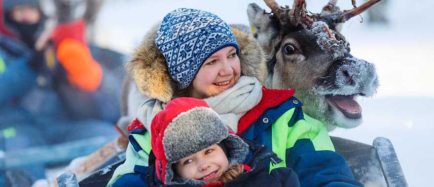 Family on reindeer safari in Finland.