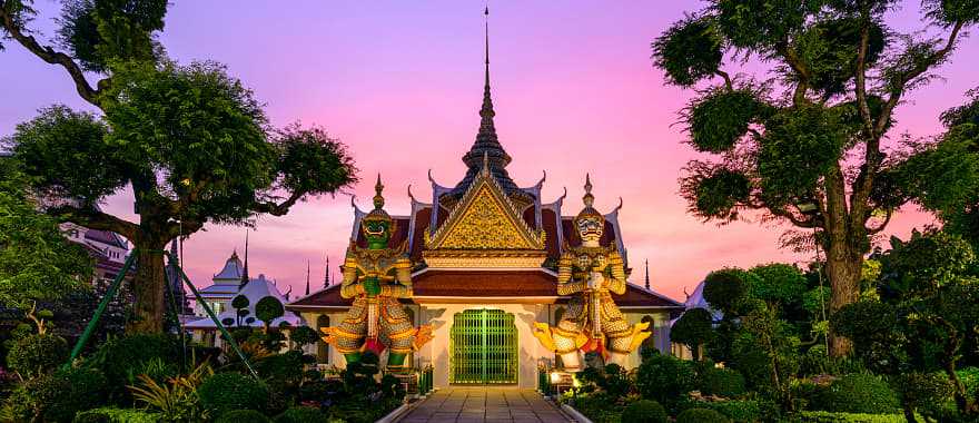 Giant statues and pagoda at Wat Arun in Bangkok Thailand.