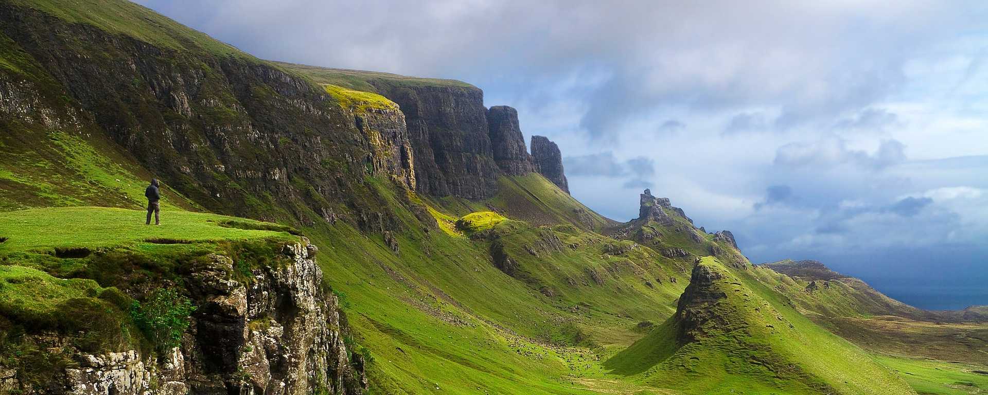 Hiker with spectacular view at the Quiraing on the Isle of Skye in Scotland