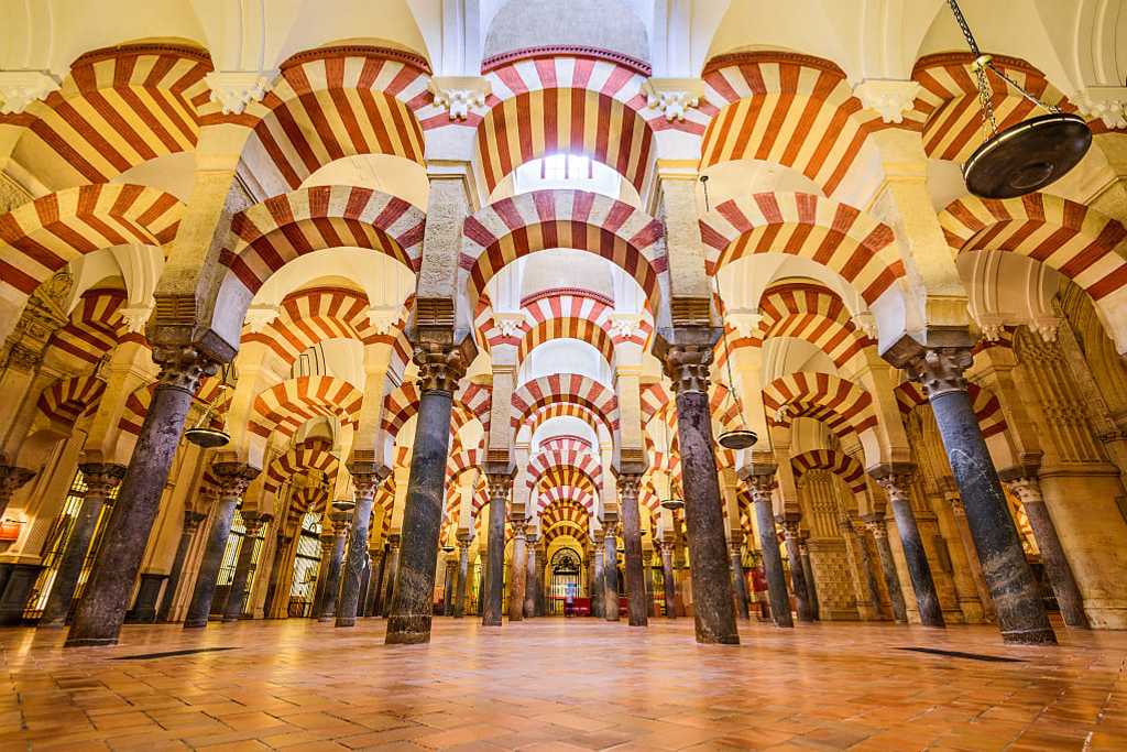 Moorish architecture of the red and white arches within the Mosque-Cathedral of Córdoba, Spain