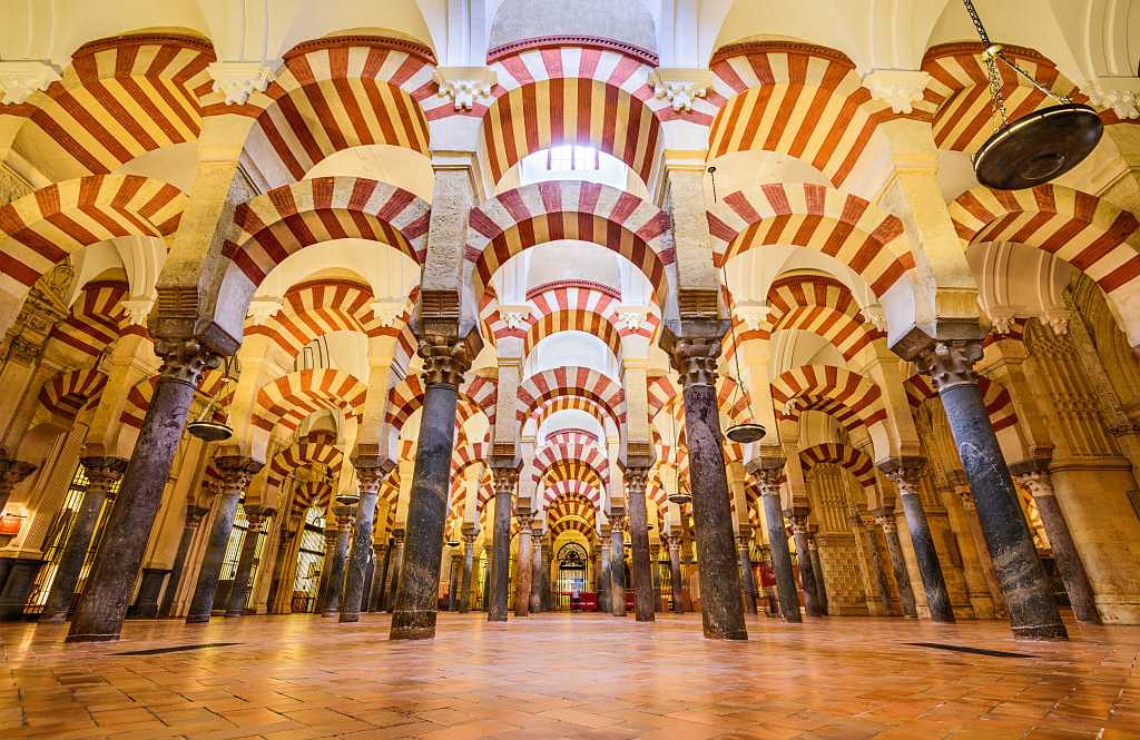 Mosque-Cathedral of Córdoba, Spain Moorish architecture of the red and white arches within the Mosque-Cathedral of Córdoba, Spain