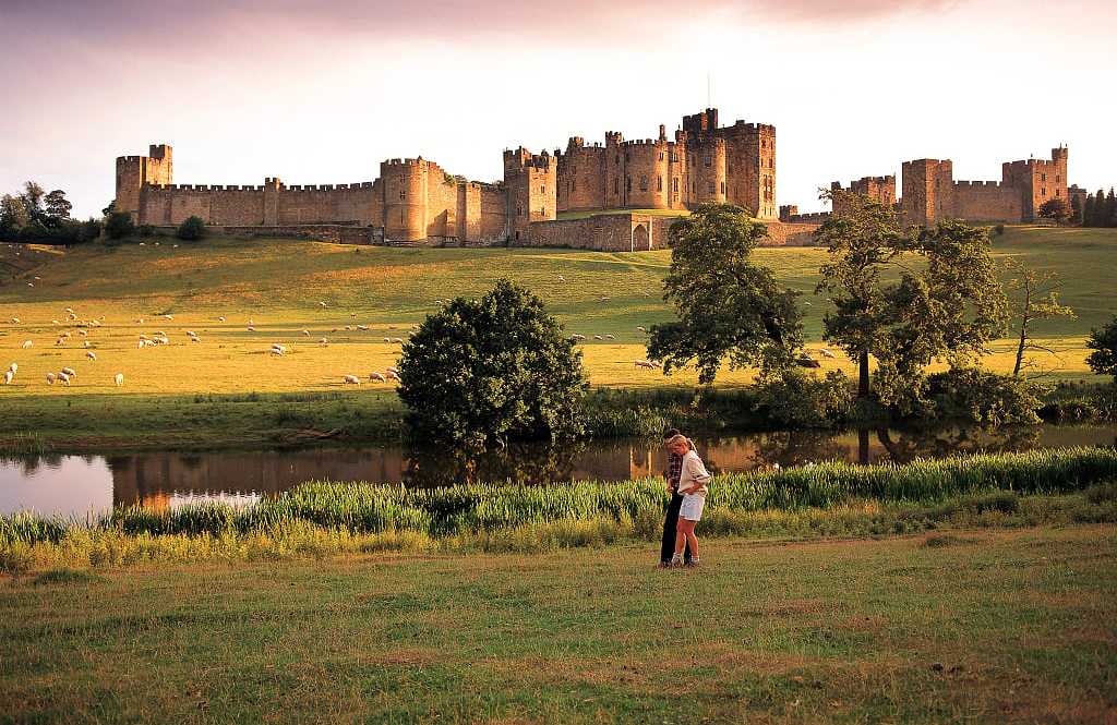 Alnwick Castle. Photo courtesy of Northumberland Tourism Couple at Alnwick Castle in Northumberland, England