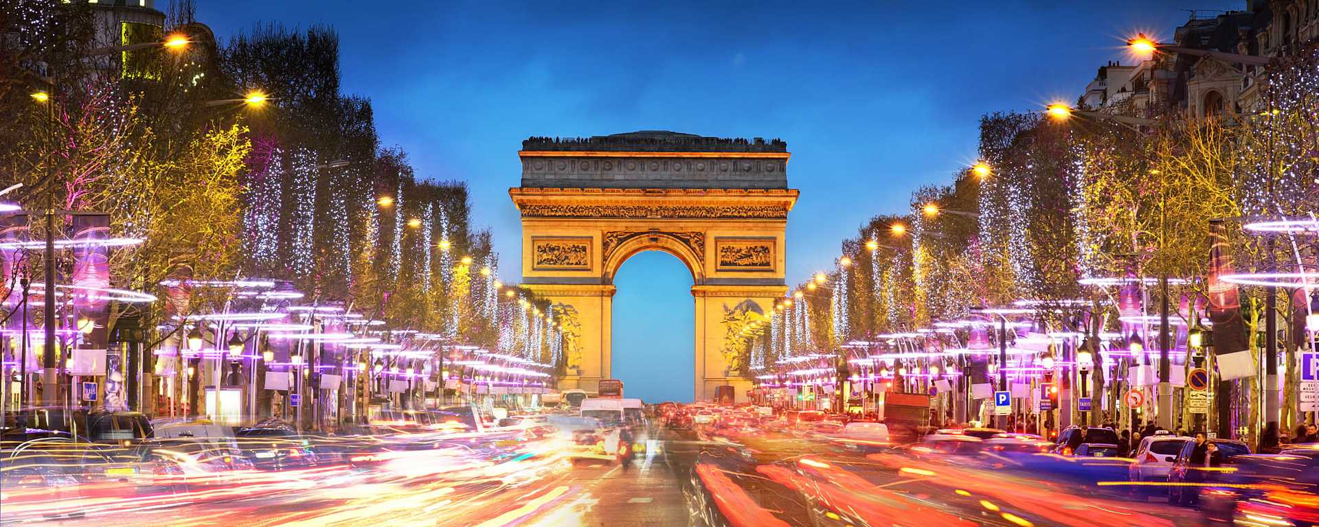 Arc de Triomphe on the Champs-Élysées at twilight in Paris, France