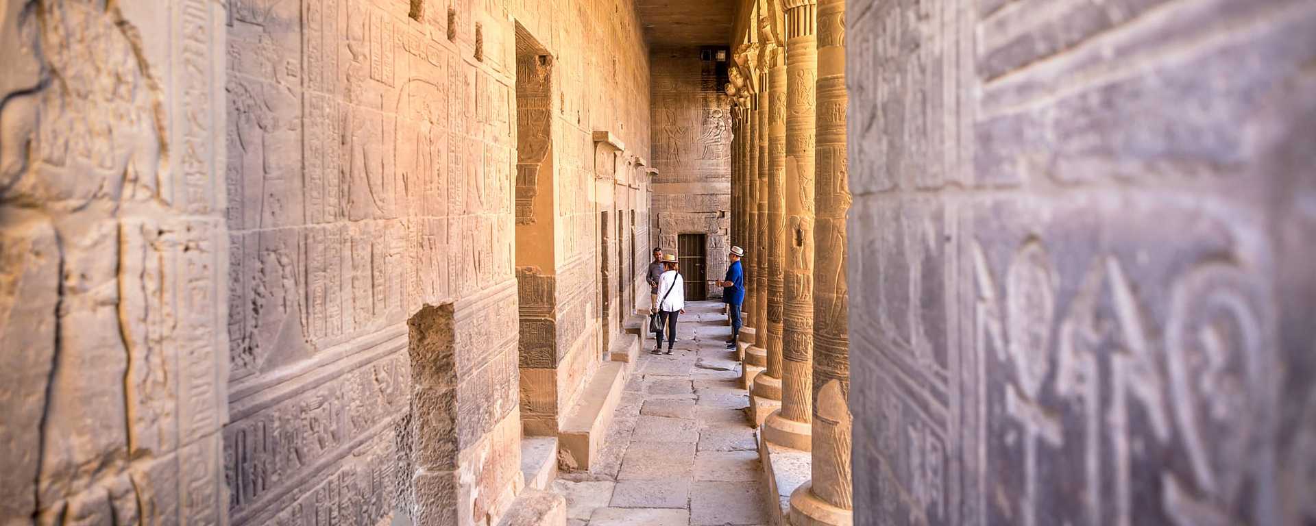 Senior travelers with guide exploring Philae Temple in Aswan, Egypt