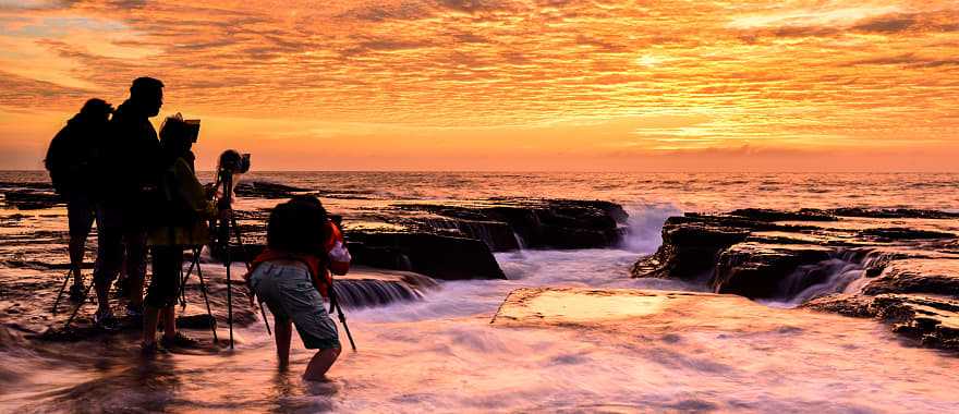 Photographers capturing sunrise on the North Narrabeen coast near Sydney, Australia