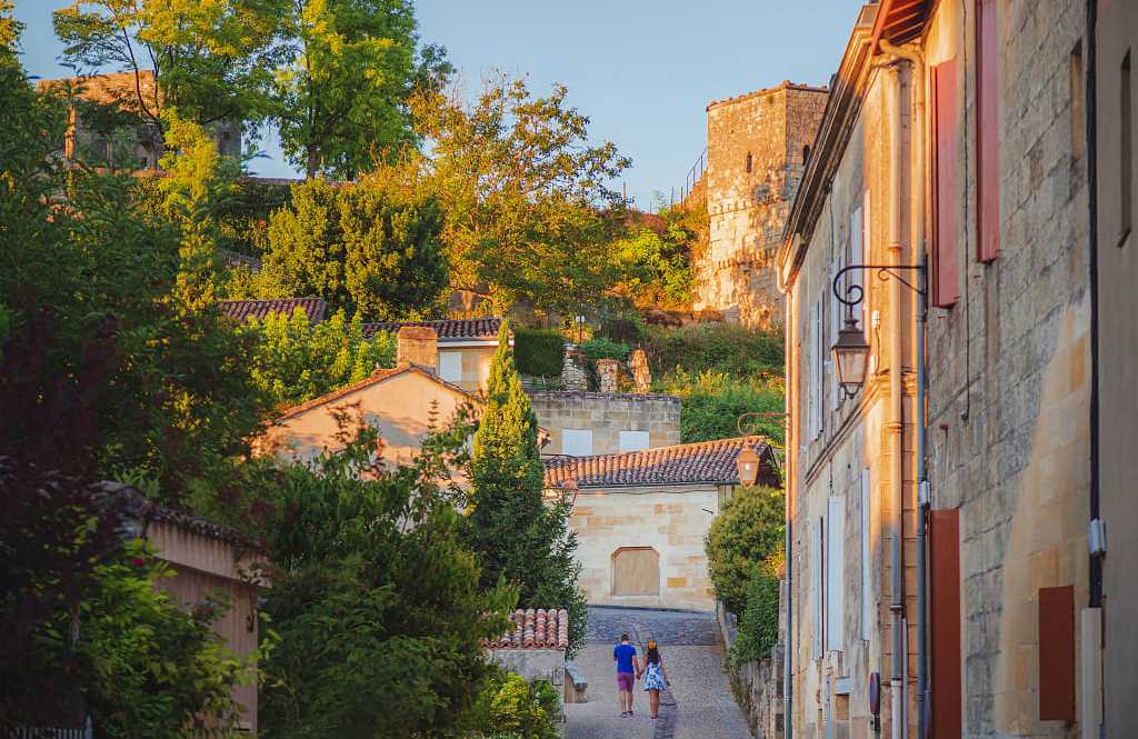 Saint-Émilion, France A couple hold hands strolling through the romantic village of Saint-Émilion in Bordeaux, France