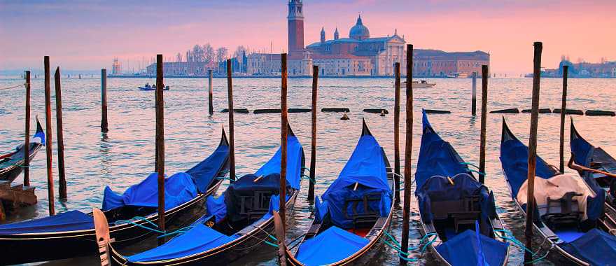 Gondolas on Venice canal at sunset in Italy
