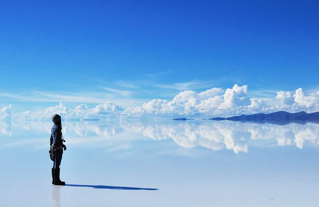 Woman with camera at Salar de Uyuni in Bolivia